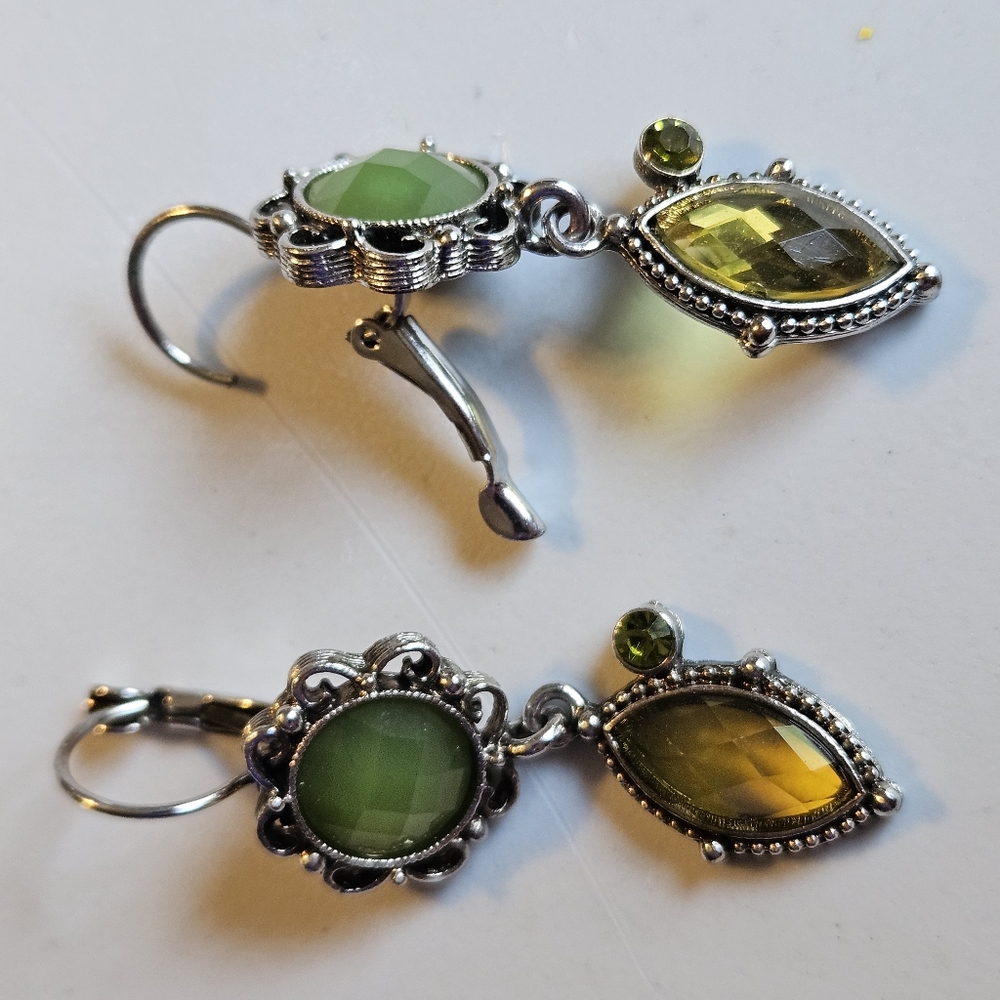 Silver tone drop earrings with green and canary gems.